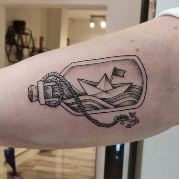 Ship in a bottle tattoo on arm