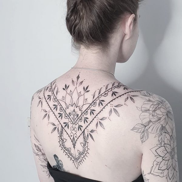 Ornamental spine tattoo