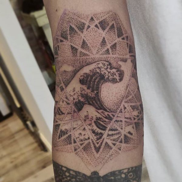 dotwork mandala and wave tattoo on arm