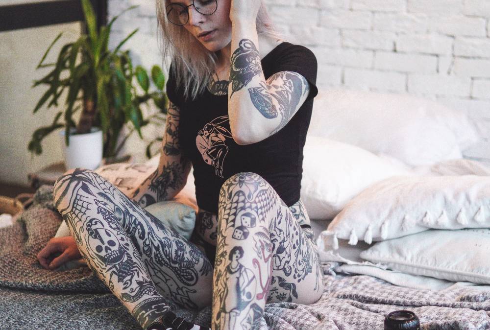 Woman with multiple black ink tattoos