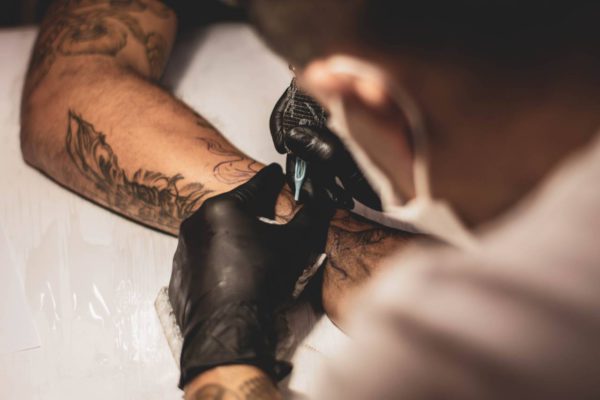 tattoo artist working on a client