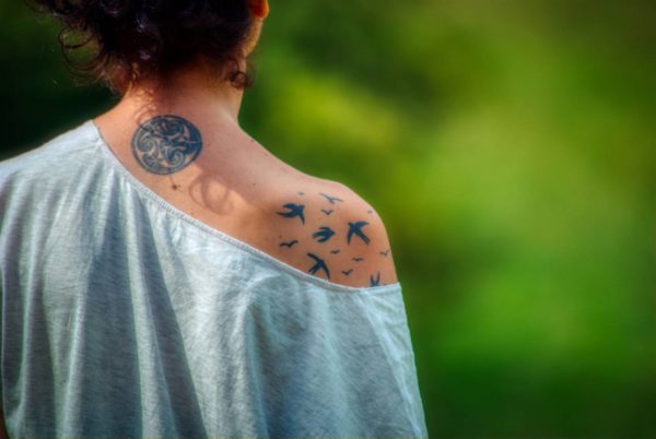 Woman with bird tattoo on shoulder